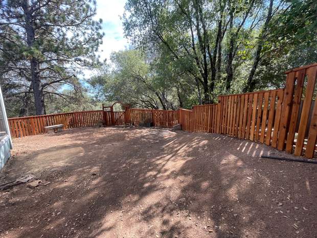 Cedar fence line enclosing cleared yard
